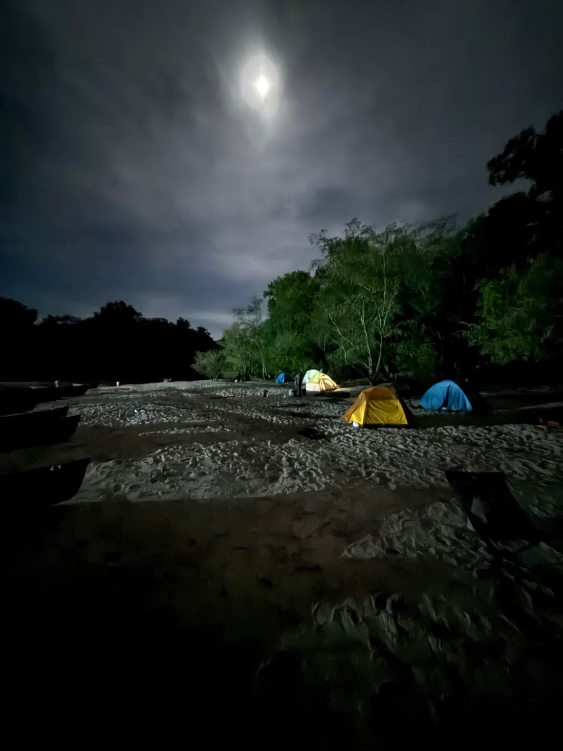 Shot of a shore line campsite in the moon light 